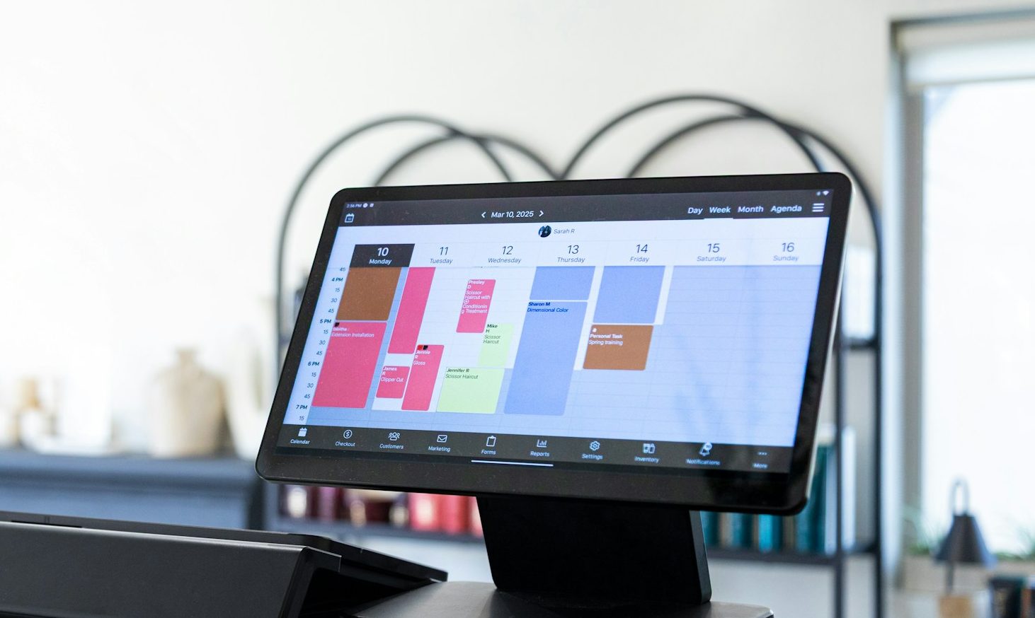 Digital appointment booking system displayed on tablet screen at a business reception desk